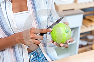 Woman holding fruit in kitchen room. woman on a diet, a woman vegetarian prepares a eat fruit