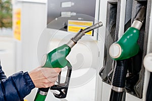 Woman holding a fuel nozzle