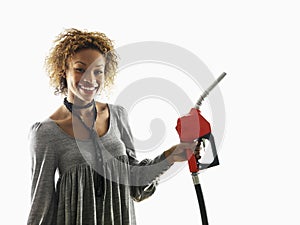 Woman holding fuel pump nozzle