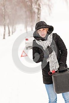 Woman holding gas can winter car breakdown