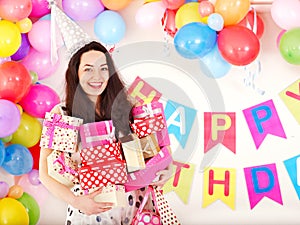 Woman holding gift box at birthday party.