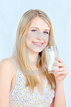 Woman holding glass of milk