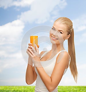 Woman holding glass of orange juice