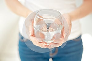 Woman holding a glass of pure water