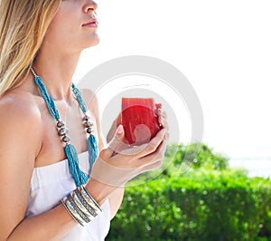 Woman holding glass of a strawberry juice