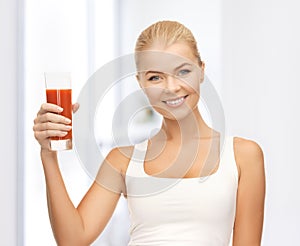 Woman holding glass of tomato juice