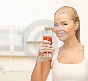 Woman holding glass of tomato juice