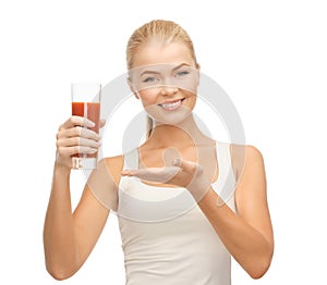 Woman holding glass of tomato juice