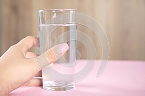 Woman holding glass of water