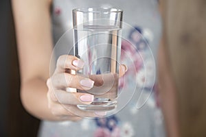 Woman holding glass of water