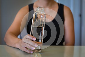 Woman holding a glass of water, on a diet. Lose weight