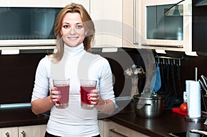 Woman holding glasses with lemonade