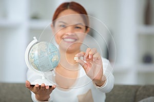 Woman holding globe and sim card