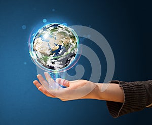 Woman holding a glowing earth globe