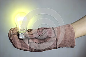 Woman holding a glowing lamp in a glove