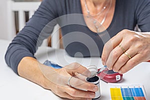 woman is holding glucometer strips