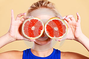 Woman holding grapefruit citrus fruit in hands