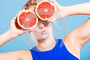 Woman holding grapefruit citrus fruit in hands