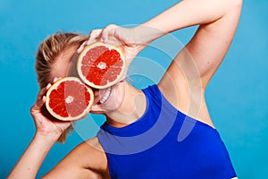 Woman holding grapefruit citrus fruit in hands