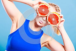 Woman holding grapefruit citrus fruit in hands