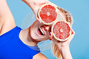 Woman holding grapefruit citrus fruit in hands