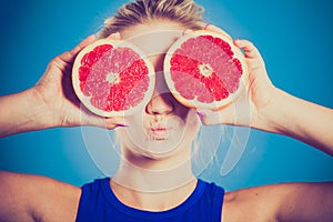 Woman holding grapefruit citrus fruit in hands