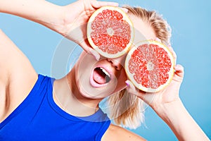 Woman holding grapefruit citrus fruit in hands