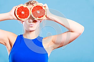 Woman holding grapefruit citrus fruit in hands