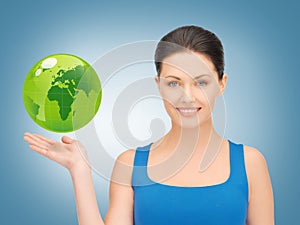 Woman holding green globe on her hand