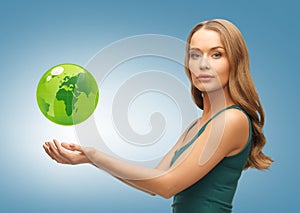 Woman holding green globe on her hands