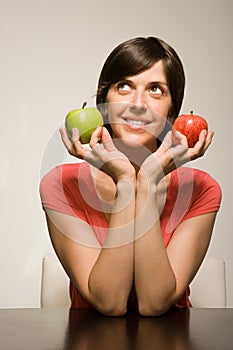 Woman holding green and red apples