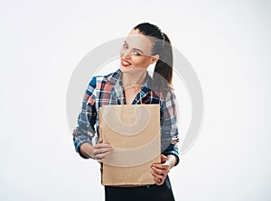 Woman is holding grocery shopping bag on white background. Paper bags in hands. Isolated background.