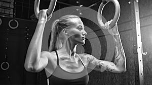 Woman holding gymnastic rings at gym