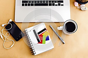 woman holding in hand different credit and bonus cards on background of laptop notebook on craft table, shopping and paying bills