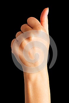 Woman holding hand in gesture of like sign, giving thumb up