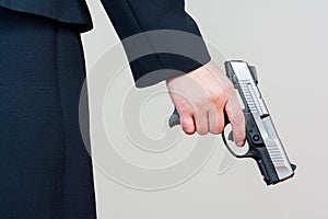 Woman holding hand gun on white background