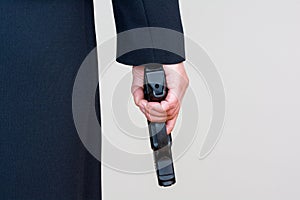 Woman holding hand gun on white background