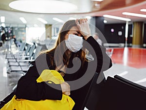 woman holding hand on head medical mask waiting passenger airport
