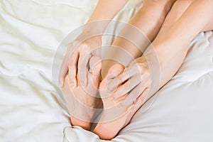 Woman holding hand to Sole of the foot, Foot ache,Health care concept,selective focus