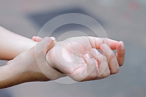 Woman holding hand to spot of wrist pain