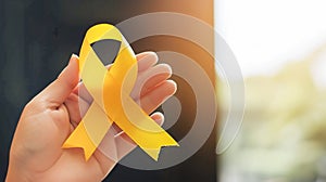 Woman holding in hand a yellow ribbon. Endometriosis suicide awareness symbol