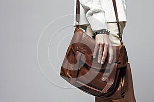 Woman holding handbag, focus on the handbag