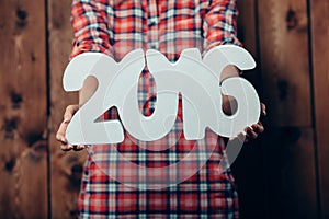 Woman holding in hands New year 2016 numbers