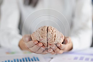 Woman holding on hands two pieces of human brain, female show fullness on person mind