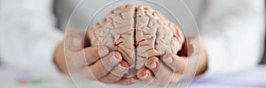 Woman holding on hands two pieces of human brain, female show fullness on person mind
