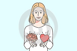 Woman holding heart and brain