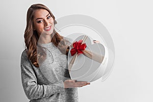 Woman holding heart shaped box