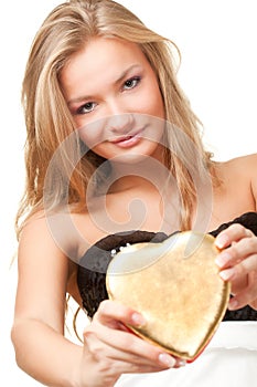 Woman holding heart shaped box