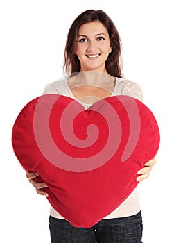 Woman holding heart-shaped pillow