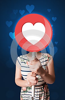 Woman holding heart sign
